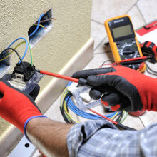 Electrician technician at work with safety equipment on a residential electrical system